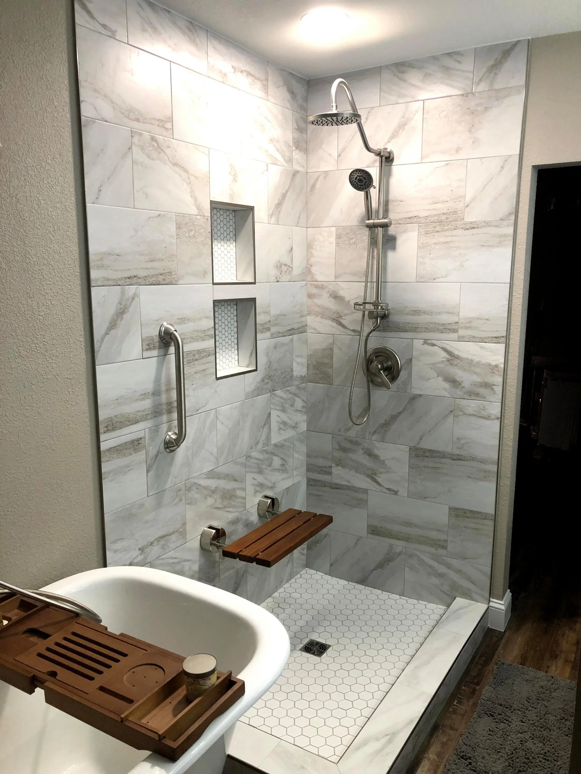 Accessible walk-in shower with natural stone tile