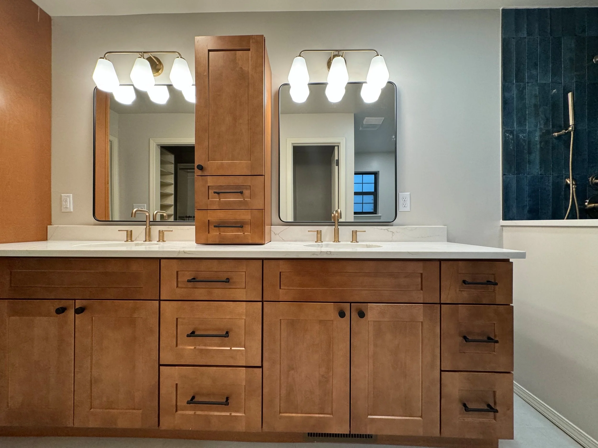 A completed modern bathroom with warm wood cabinetry